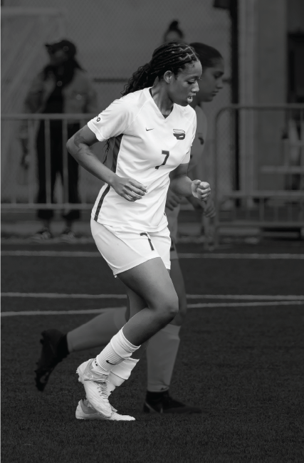TMU women soccer player running on the soccer field